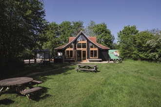 Hickling visitor centre at the back of a patch of grass on a sunny day